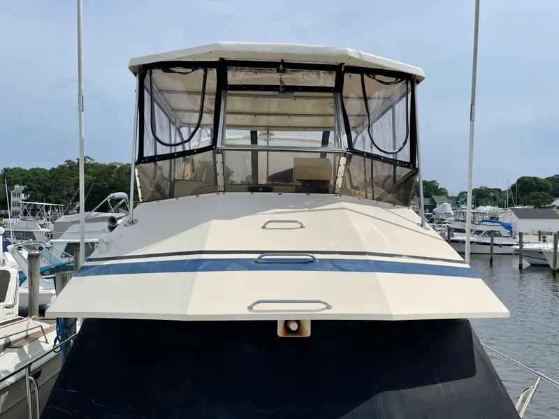 Slide: The Image of 1989 Hi-Star 55 Pilothouse yacht docked at a marina, featuring a spacious pilothouse. - 28