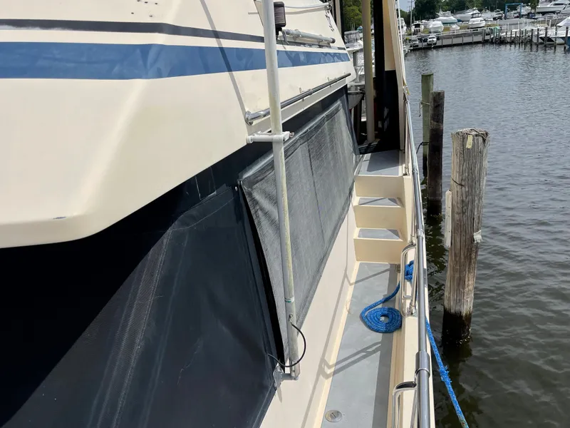 Slide: The Image of 1989 Hi-Star 55 Pilothouse yacht docked, showing side deck and railing. - 29