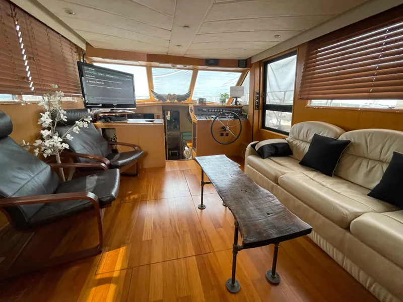 Slide: The Image of Luxurious 1989 Hi-Star 55 Pilothouse interior with leather seating and wooden accents. - 8