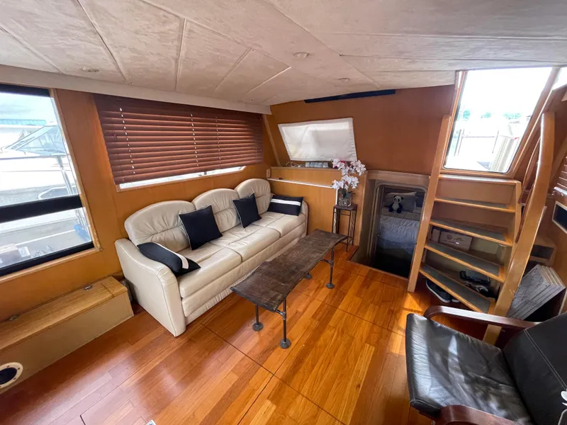 Slide: The Image of Luxurious 1989 Hi-Star 55 Pilothouse interior with leather sofa and wooden flooring. - 9