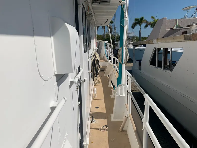 Slide: The Image of Side deck of a 1970 Custom Dive Vessel in a marina. - 21
