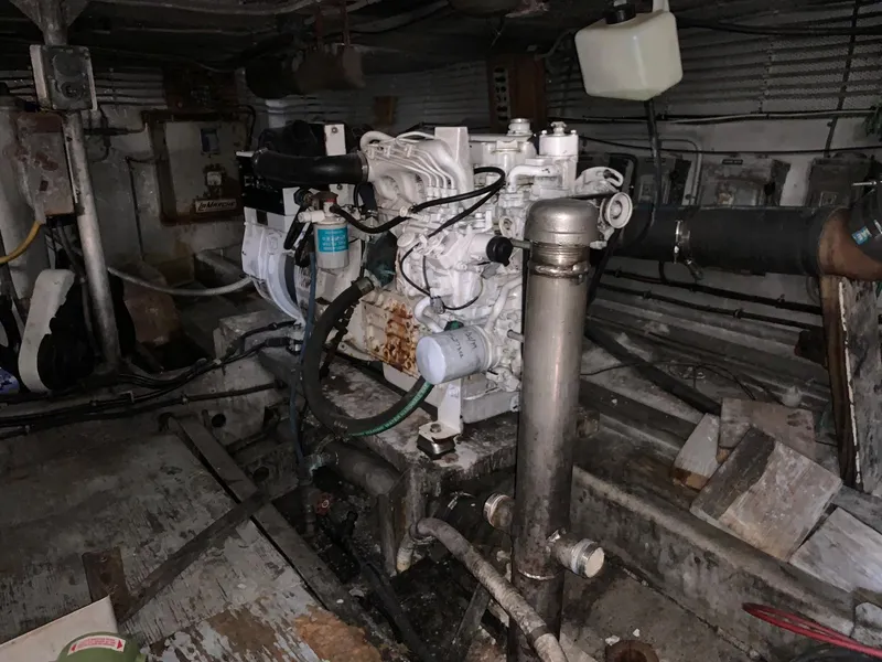 Slide: The Image of Engine room of a 1970 Custom Dive Vessel with visible machinery and pipes. - 32