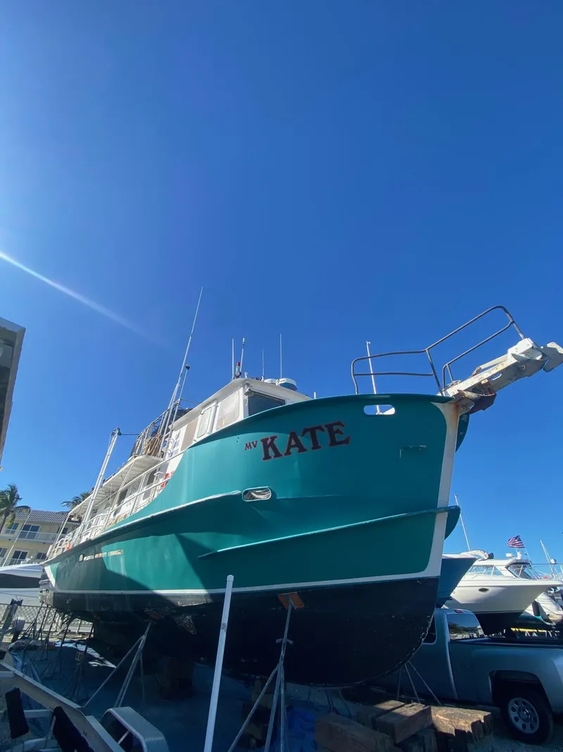 Slide: The Image of Custom 1970 dive vessel Kate on dry dock under clear blue sky. - 45