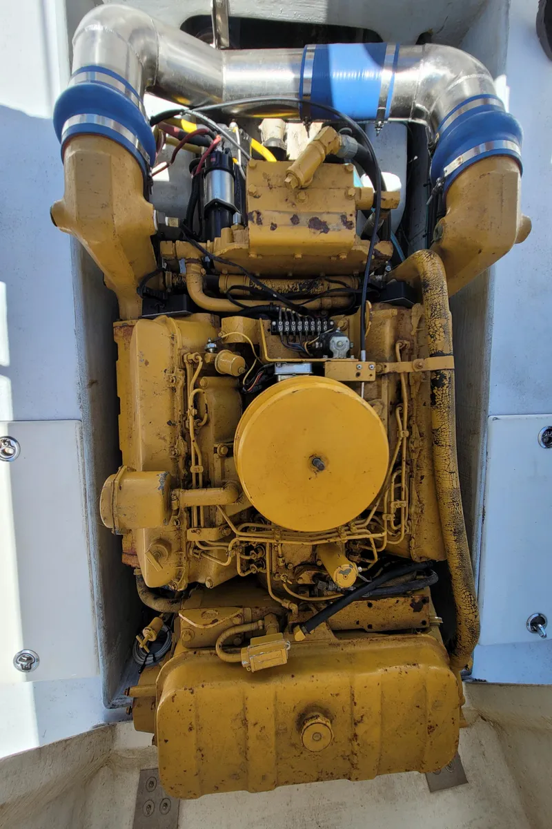Slide: The Image of 1989 C-Hawk 29 engine compartment with yellow marine engine. - 18