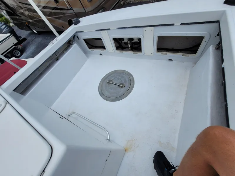 Slide: The Image of 1989 C-Hawk 29 boat deck with storage compartments and hatch. - 5