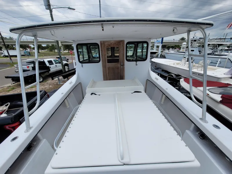 Slide: The Image of 1989 C-Hawk 29 boat with spacious deck and cabin, docked at marina. - 6