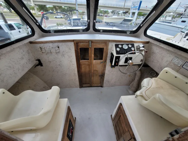 Slide: The Image of 1989 C-Hawk 29 boat interior with steering wheel and seating. - 7