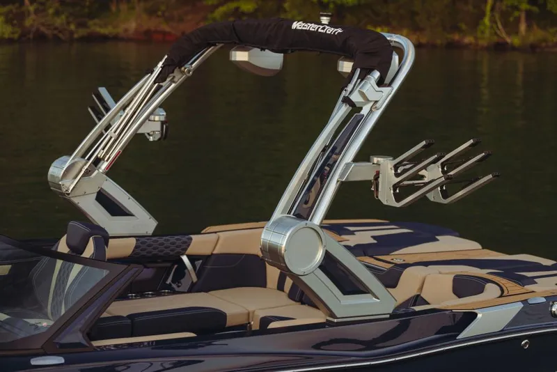 Slide: The Image of 2023 MasterCraft XT22 T boat with wakeboard tower on calm water. - 11