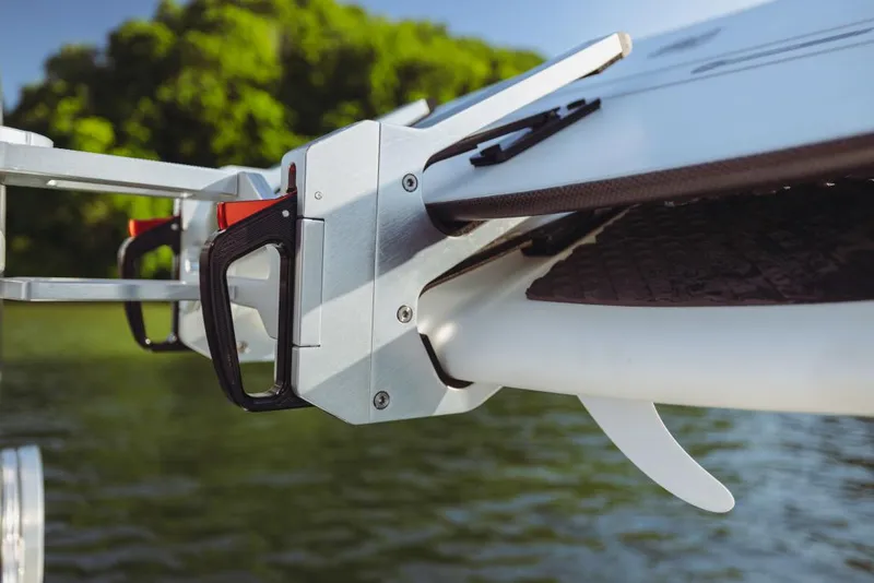 Slide: The Image of 2023 MasterCraft XT22 T boat with surfboard rack on a lake. - 14