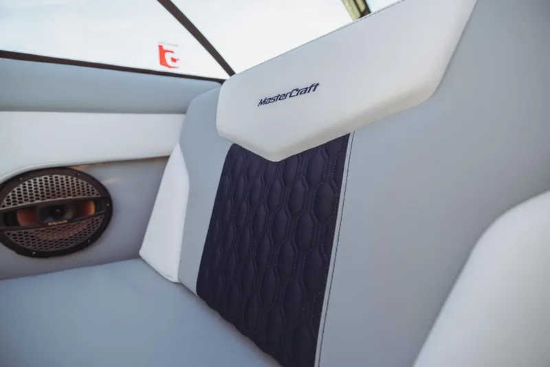 Slide: The Image of 2023 MasterCraft XT22 T boat interior with premium seating and speaker. - 17