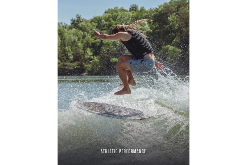 Slide: The Image of Person wakesurfing behind 2023 MasterCraft XT22 T boat on a sunny day. - 6