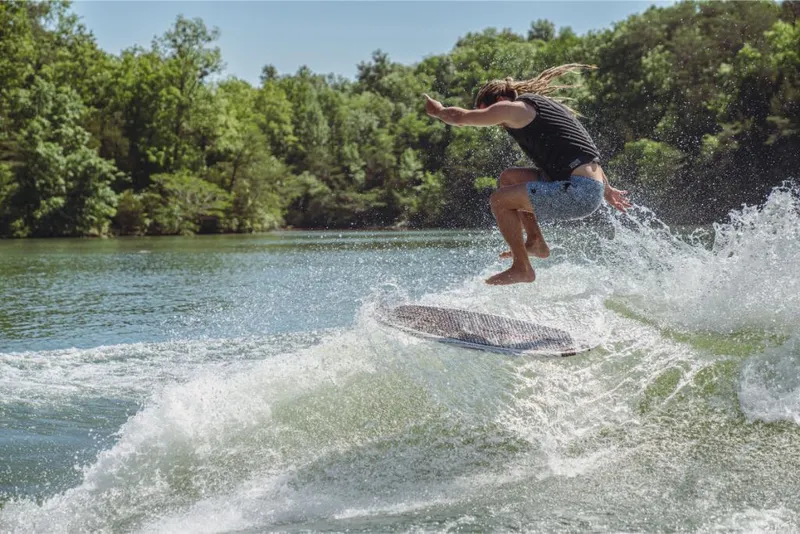 Slide: The Image of Person wakesurfing behind a 2023 MasterCraft XT22 T boat on a sunny day. - 9