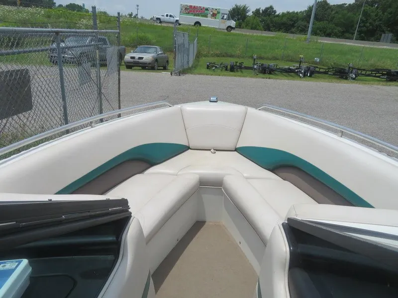 Slide: The Image of 1997 MasterCraft PT205 boat interior with white and teal seating. - 10