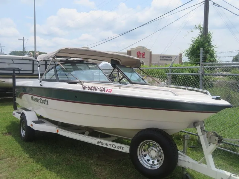 Slide: The Image of 1997 MasterCraft PT205 boat on trailer, parked outdoors. - 3