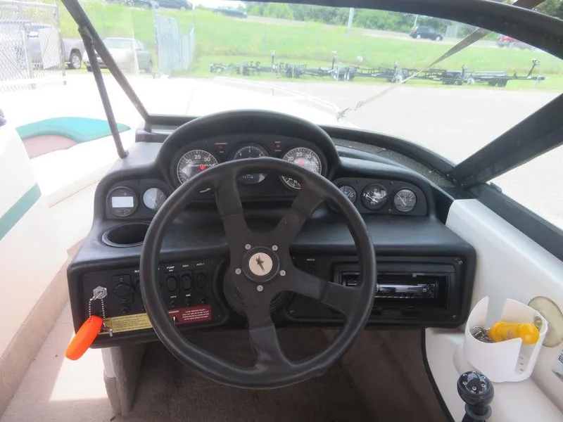 Slide: The Image of 1997 MasterCraft PT205 boat dashboard with steering wheel and instrument panel. - 7