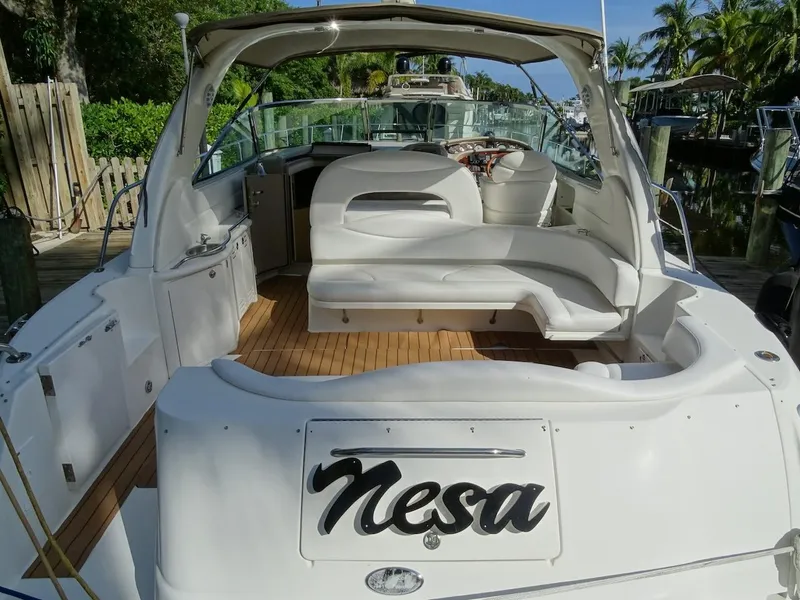 Slide: The Image of 2001 Sea Ray 410 Sundancer yacht with white seating and wooden deck. - 0