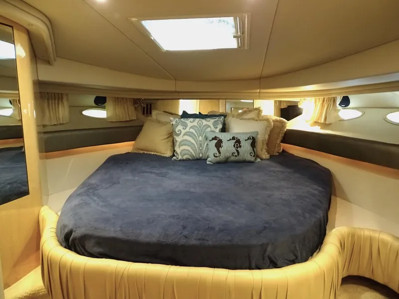 Slide: The Image of Luxurious bedroom interior of 2001 Sea Ray 410 Sundancer yacht with plush bedding. - 16