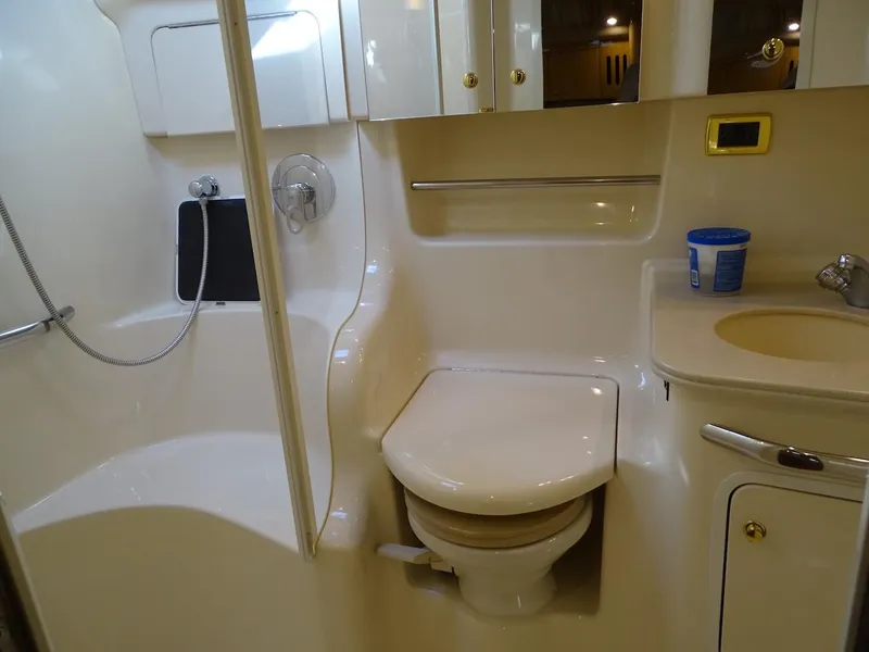 Slide: The Image of 2001 Sea Ray 410 Sundancer bathroom with shower, toilet, and sink. - 18