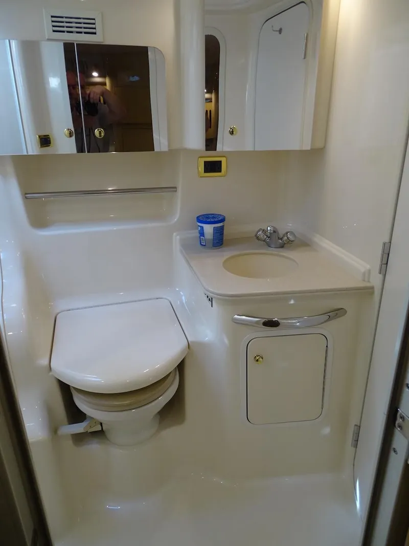 Slide: The Image of 2001 Sea Ray 410 Sundancer bathroom with toilet, sink, and storage. - 19