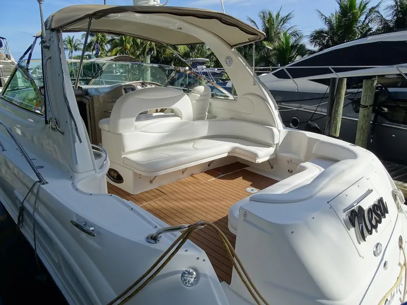 Slide: The Image of 2001 Sea Ray 410 Sundancer yacht with spacious seating and teak deck, docked at marina. - 2