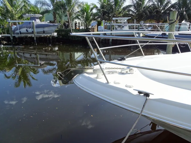 Slide: The Image of 2001 Sea Ray 410 Sundancer docked near palm trees and other boats. - 24