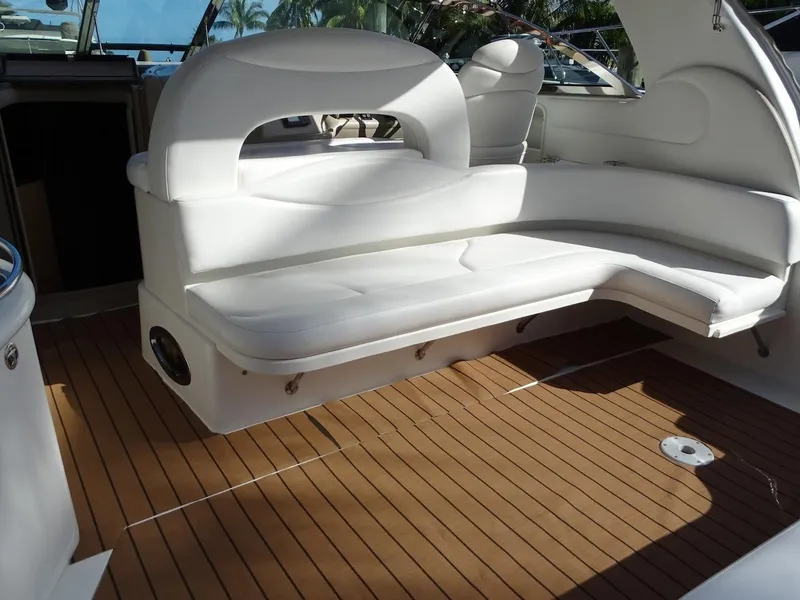 Slide: The Image of 2001 Sea Ray 410 Sundancer boat interior with white seating and wooden flooring. - 3