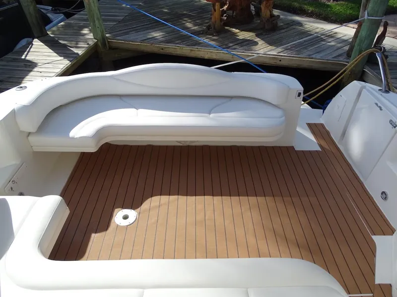 Slide: The Image of 2001 Sea Ray 410 Sundancer boat deck with white seating and wooden flooring. - 4