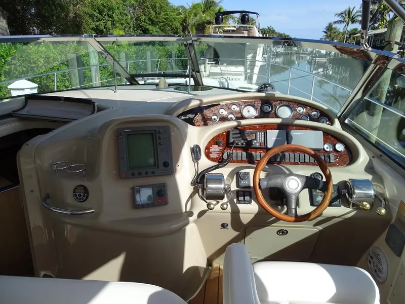 Slide: The Image of Helm of 2001 Sea Ray 410 Sundancer yacht with navigation equipment and steering wheel. - 5