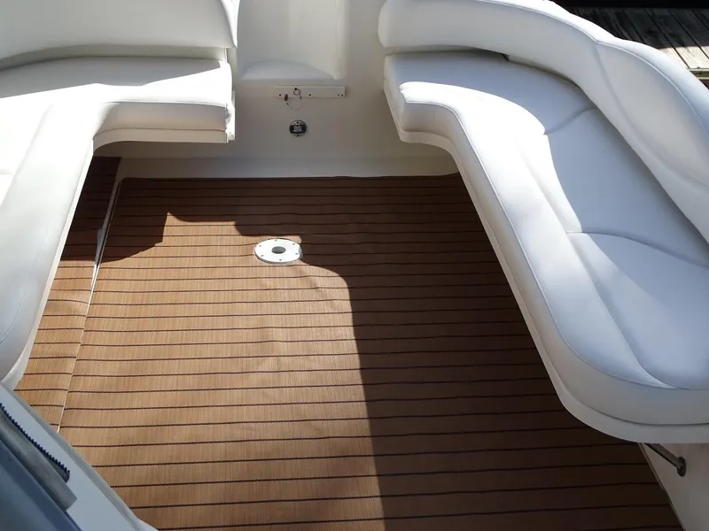 Slide: The Image of 2001 Sea Ray 410 Sundancer cockpit with white seating and teak flooring. - 6