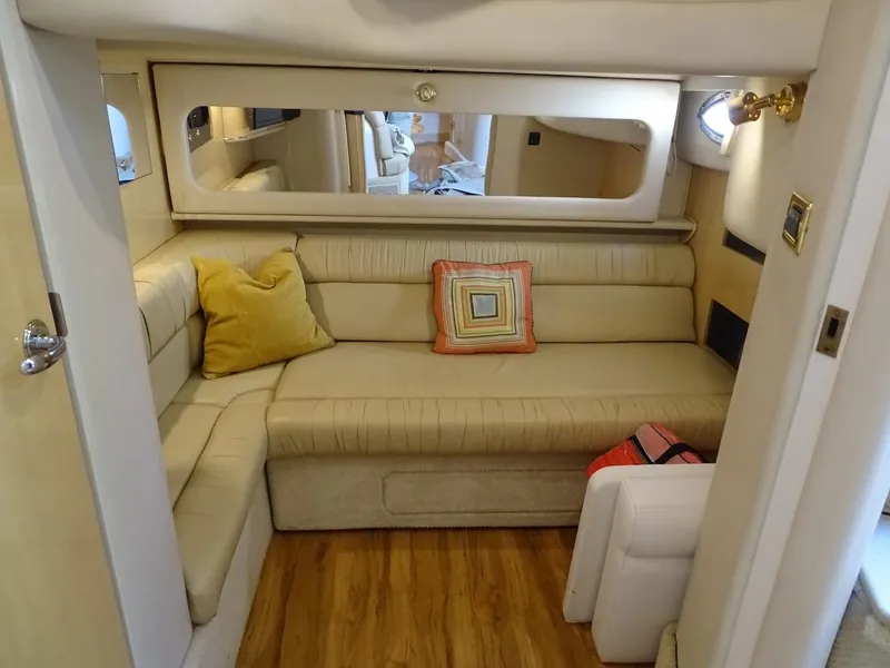 Slide: The Image of Interior of 2001 Sea Ray 410 Sundancer with beige seating and decorative pillows. - 7