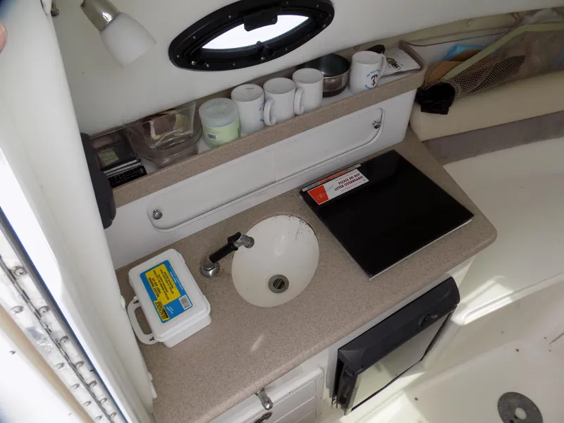 Slide: The Image of 2006 Century 24 WALKAROUND boat interior with sink, countertop, and storage. - 10