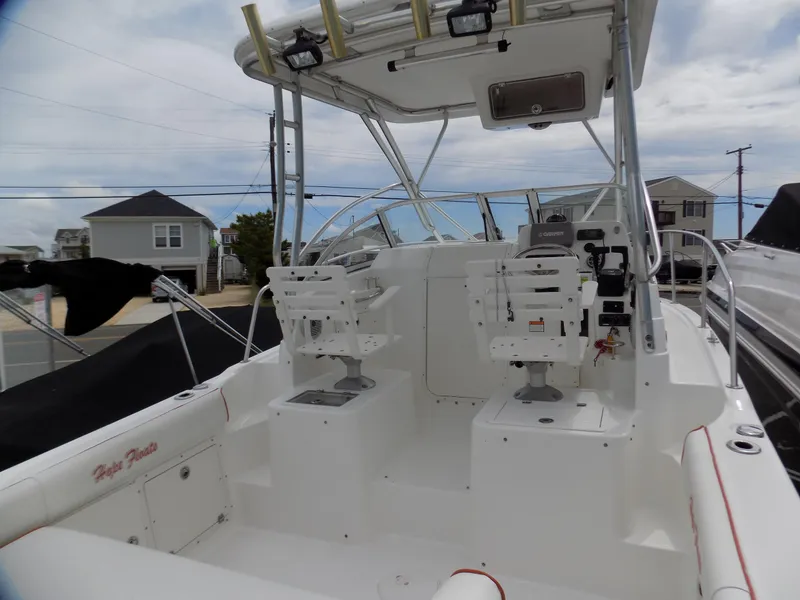 Slide: The Image of 2006 Century 24 WALKAROUND boat interior with dual seats and fishing rod holders. - 4