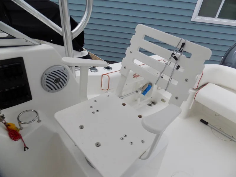 Slide: The Image of 2006 Century 24 WALKAROUND boat interior with white seating and control panel. - 6