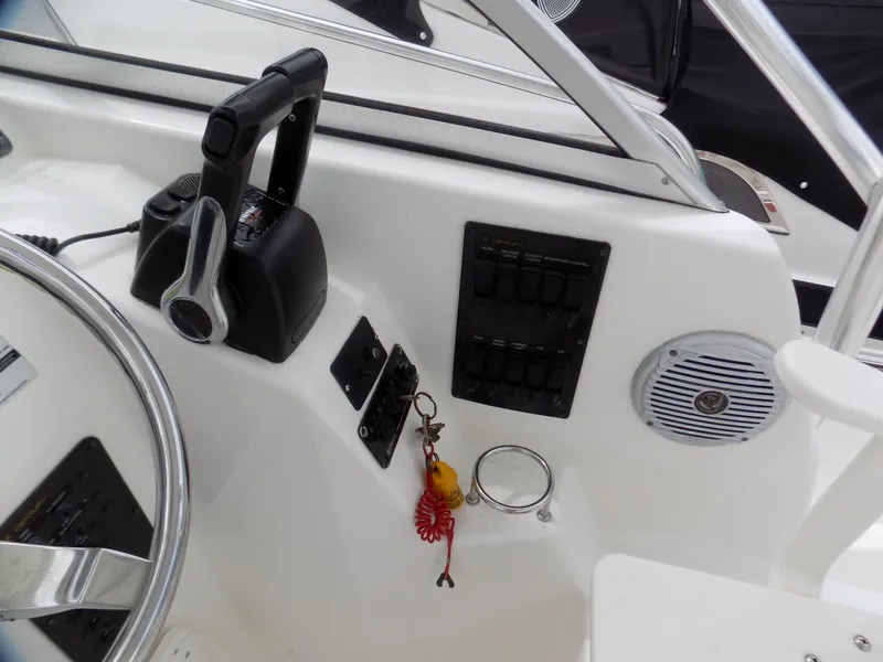 Slide: The Image of Control panel of a 2006 Century 24 WALKAROUND boat with steering wheel and switches. - 8