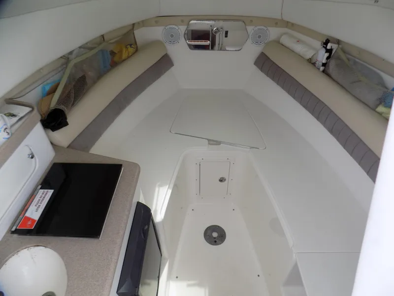 Slide: The Image of Interior of a 2006 Century 24 Walkaround boat, featuring seating and storage. - 9