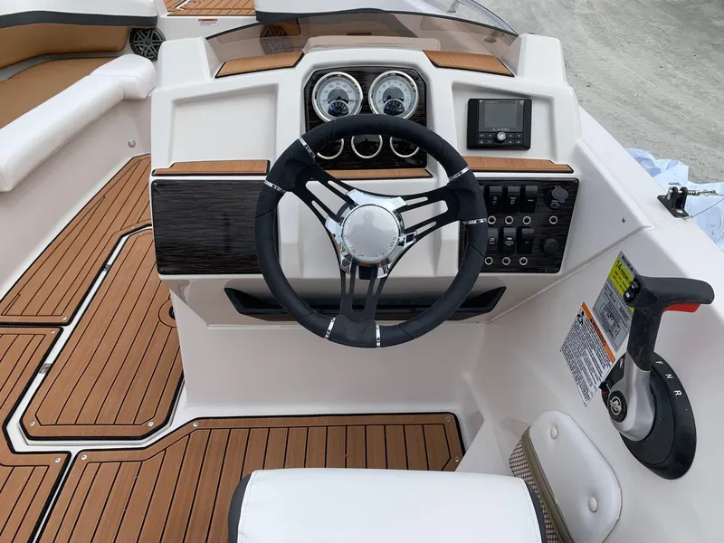 Slide: The Image of 2024 Starcraft SVX 211 boat dashboard with steering wheel and control panel. - 10
