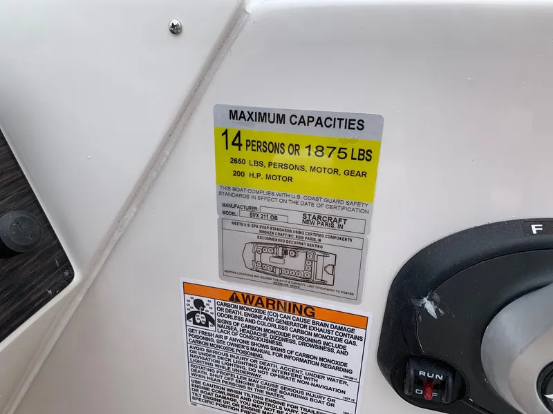 Slide: The Image of 2024 Starcraft SVX 211 boat capacity label, 14 persons or 1875 lbs, 200 HP motor. - 14