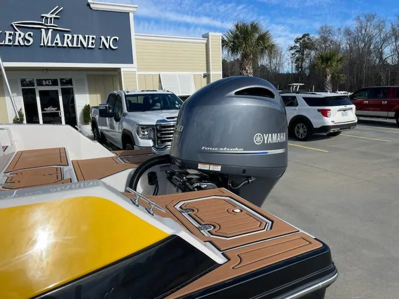 Slide: The Image of 2024 Starcraft SVX 211 boat with Yamaha outboard motor at dealership. - 2