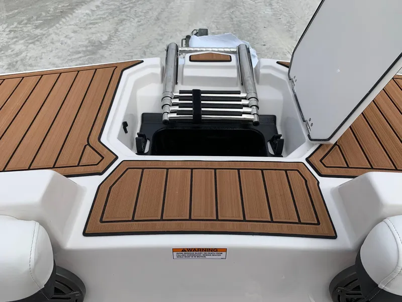 Slide: The Image of 2024 Starcraft SVX 211 boat with teak-style deck and foldable ladder. - 4