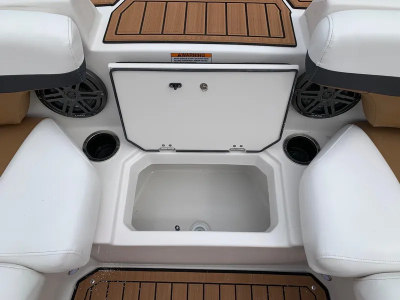 Slide: The Image of 2024 Starcraft SVX 211 boat interior with storage compartment and cup holders. - 5