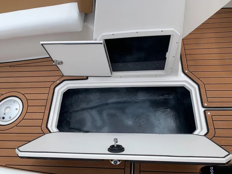 Slide: The Image of 2024 Starcraft SVX 211 boat storage compartments on teak deck. - 7