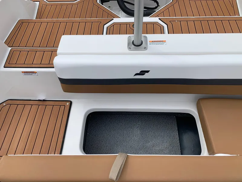 Slide: The Image of 2024 Starcraft SVX 211 boat interior with teak flooring and storage compartment. - 9