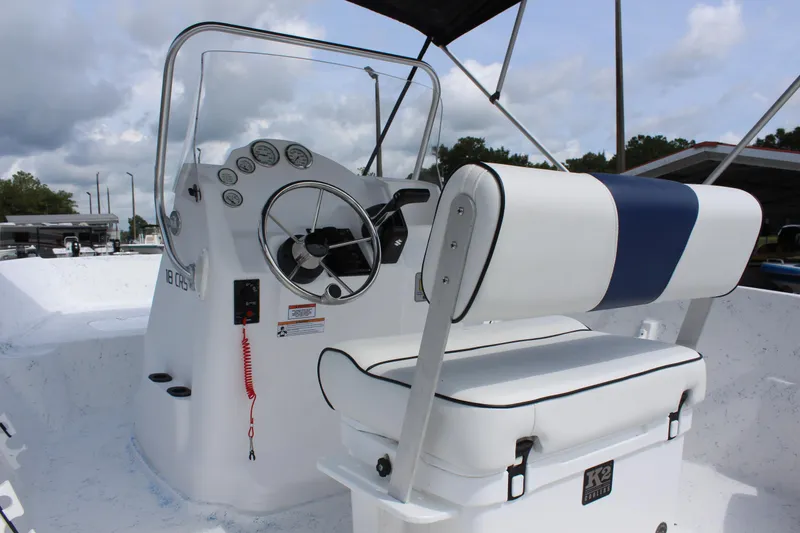 Slide: The Image of 2022 ALK2 Powerboats 18 CRS console and seating area with steering wheel and gauges. - 8