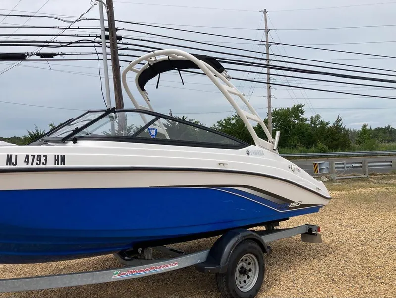 Slide: The Image of 2020 Yamaha Boats AR 190 on trailer, blue and white, side view. - 11