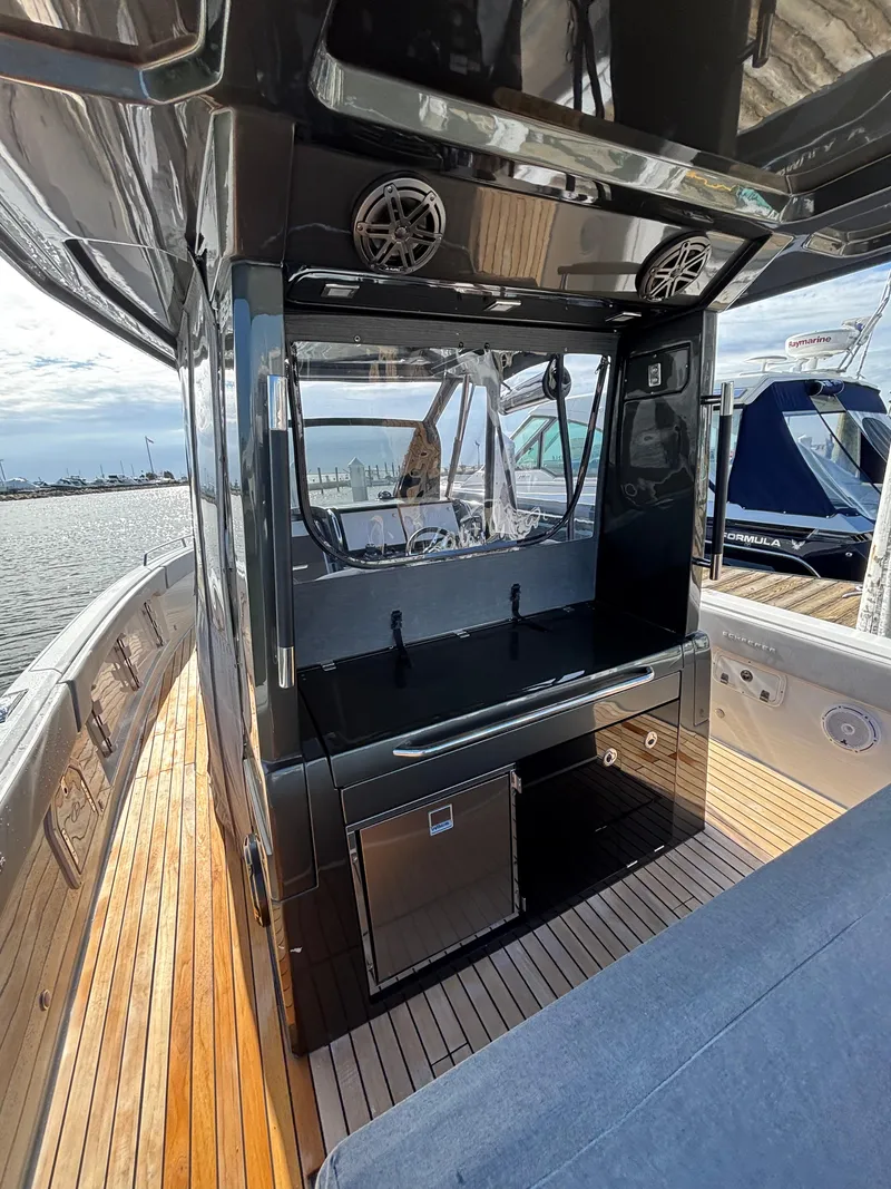 Slide: The Image of 2023 Schaefer V33 boat with twin Mercury engines, docked at a marina. - 9