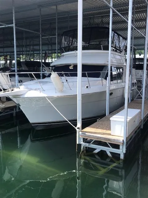 The Image of 1996 Carver 370 yacht docked in a covered marina. - 0