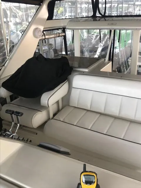 Slide: The Image of 1996 Carver 370 boat helm with steering wheel and control panel. - 10