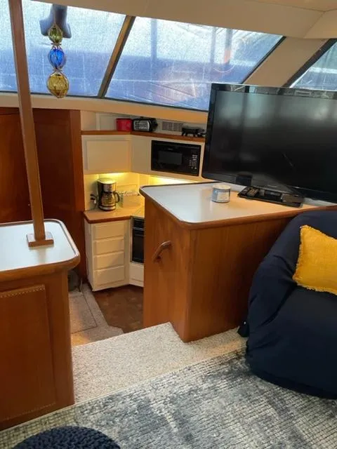 Slide: The Image of Interior of 1996 Carver 370 yacht with kitchen and living area. - 17