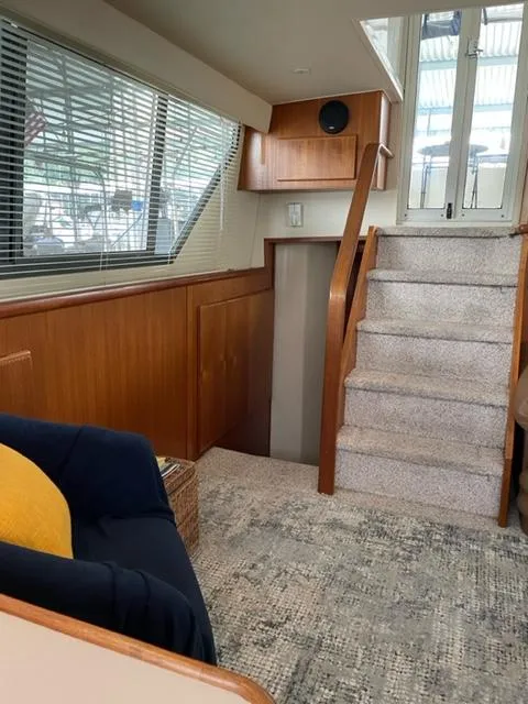 Slide: The Image of Interior of 1996 Carver 370 yacht with cozy seating and TV. - 19