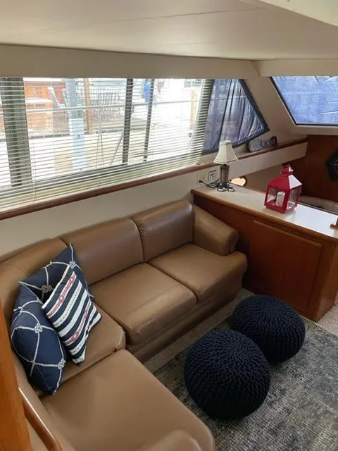 Slide: The Image of 1996 Carver 370 boat bathroom with sink, toilet, and storage shelves. - 25